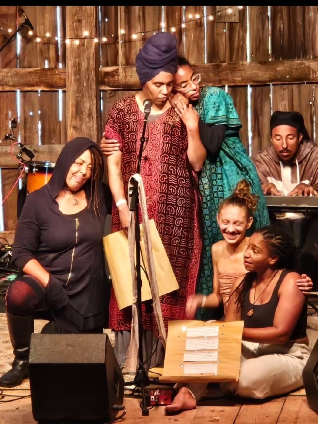 Group of performers sharing an emotional moment during a live presentation
